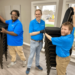 Extraordinary Ventures employees putting chairs away
